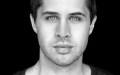 black and white headshot of young Caucasian man with intense eyes. James Simpson.